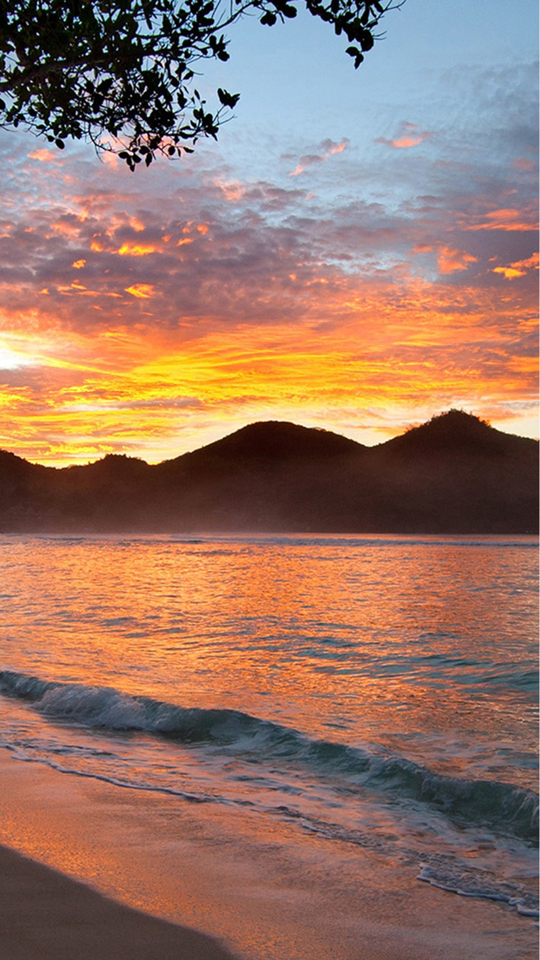 Sunset with mountains on beach Android wallpaper